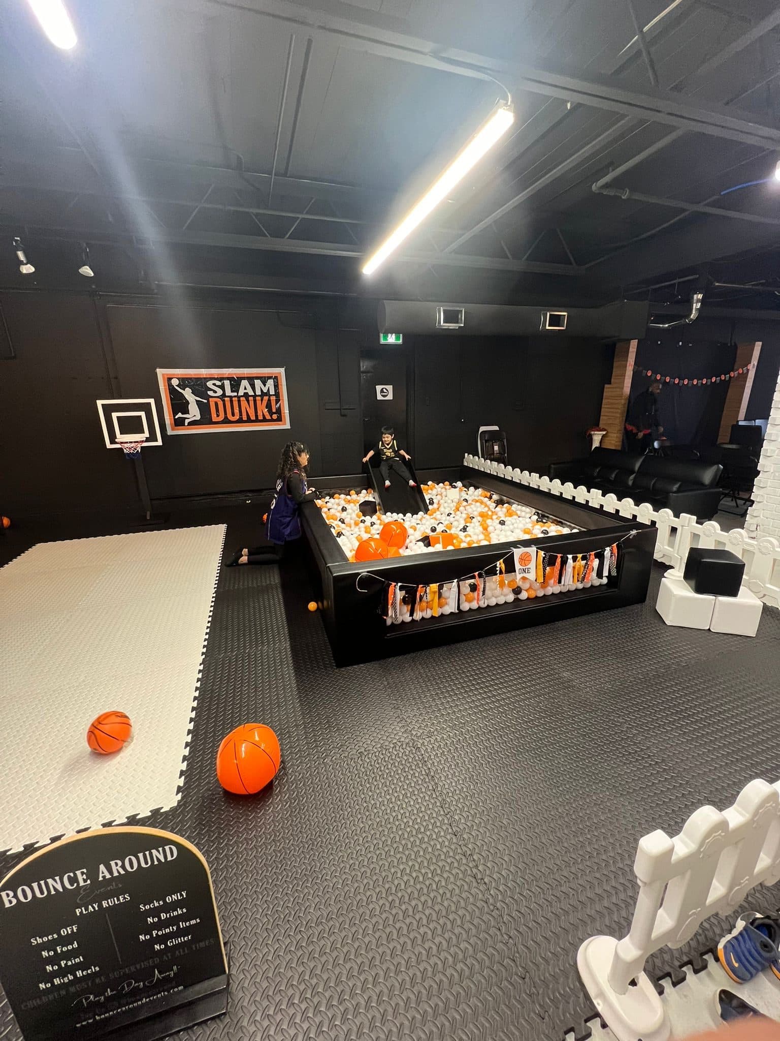 A kids' party at Half Note with a ball pit, a basketball hoop and foam floor mats.